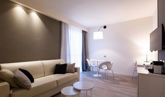 junior suite room, ca. 44 sqm, 1 king size bed and 1 single sofa bed, desk, free wifi, kettle, bathrobe with slippers and courtesy kit, minibar, segafredo coffee machine, safe, lcd tv with sky, free parking and fitness room on the 18th floor