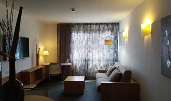 suite-1 queen bed, sofabed for two, lounge area, two televisions