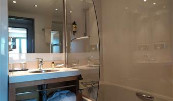 suite-1 queen bed, sofabed for two, lounge area, two televisions