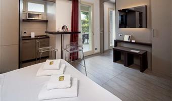 suite-1 king bed, non-smoking room, double sofabed, living area, 2 32 inch led tvs, kitchenette, patio