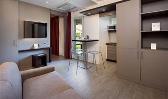 suite-1 king bed, non-smoking room, double sofabed, living area, 2 32 inch led tvs, kitchenette, patio