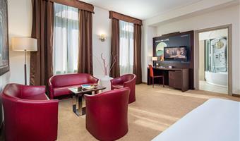 superior room with balchony with king size bed convertible in 2 twin beds and a single bed, sofa and free bottle of water