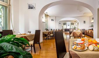 superior room with balchony with king size bed convertible in 2 twin beds and a single bed, sofa and free bottle of water